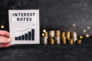 A sign that says “interest rates” with an arrow going upwards